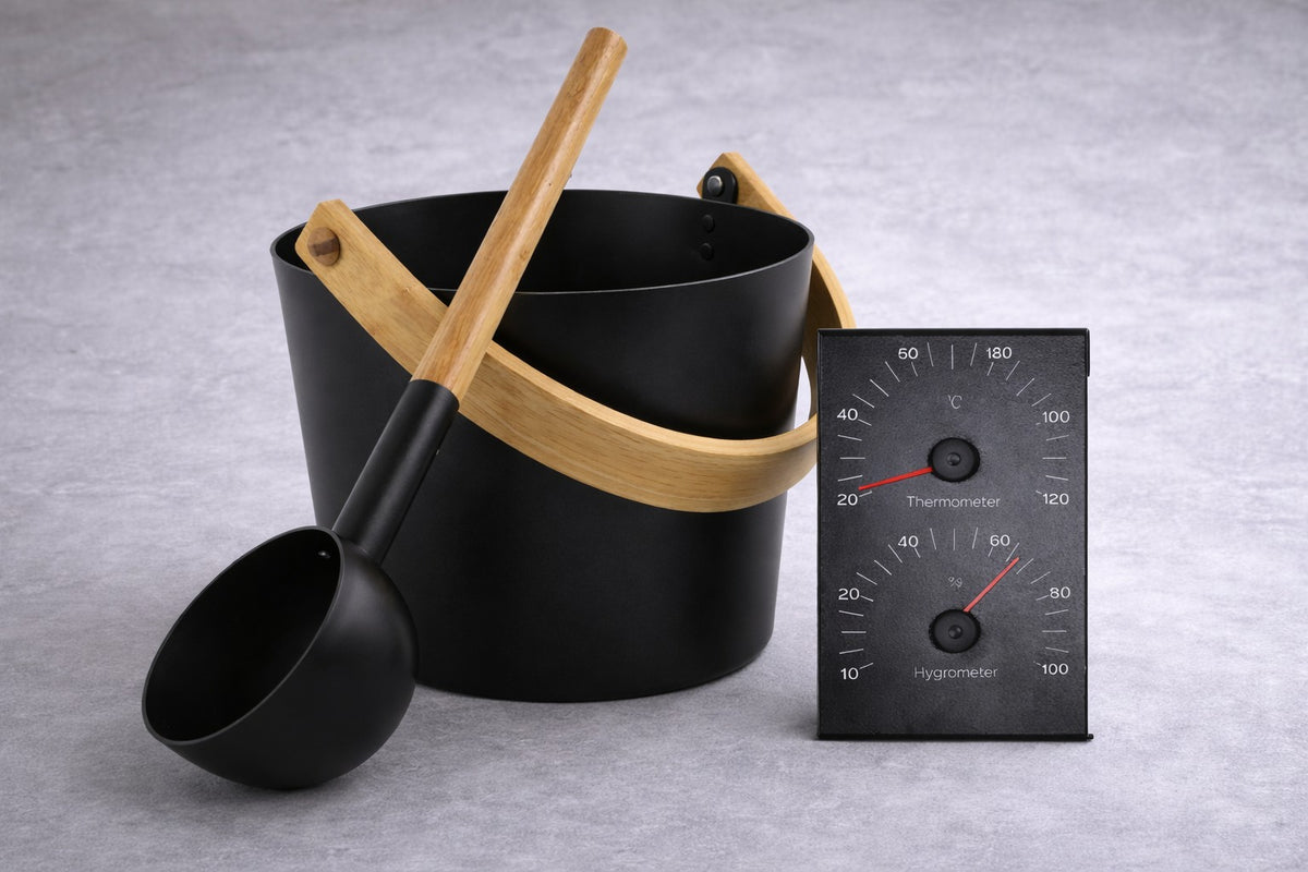 The Procraft black and bamboo sauna accessory kit: the black bucket with its bamboo handle, the matching black and bamboo ladle, and the black thermometer and hygrometer gauge.